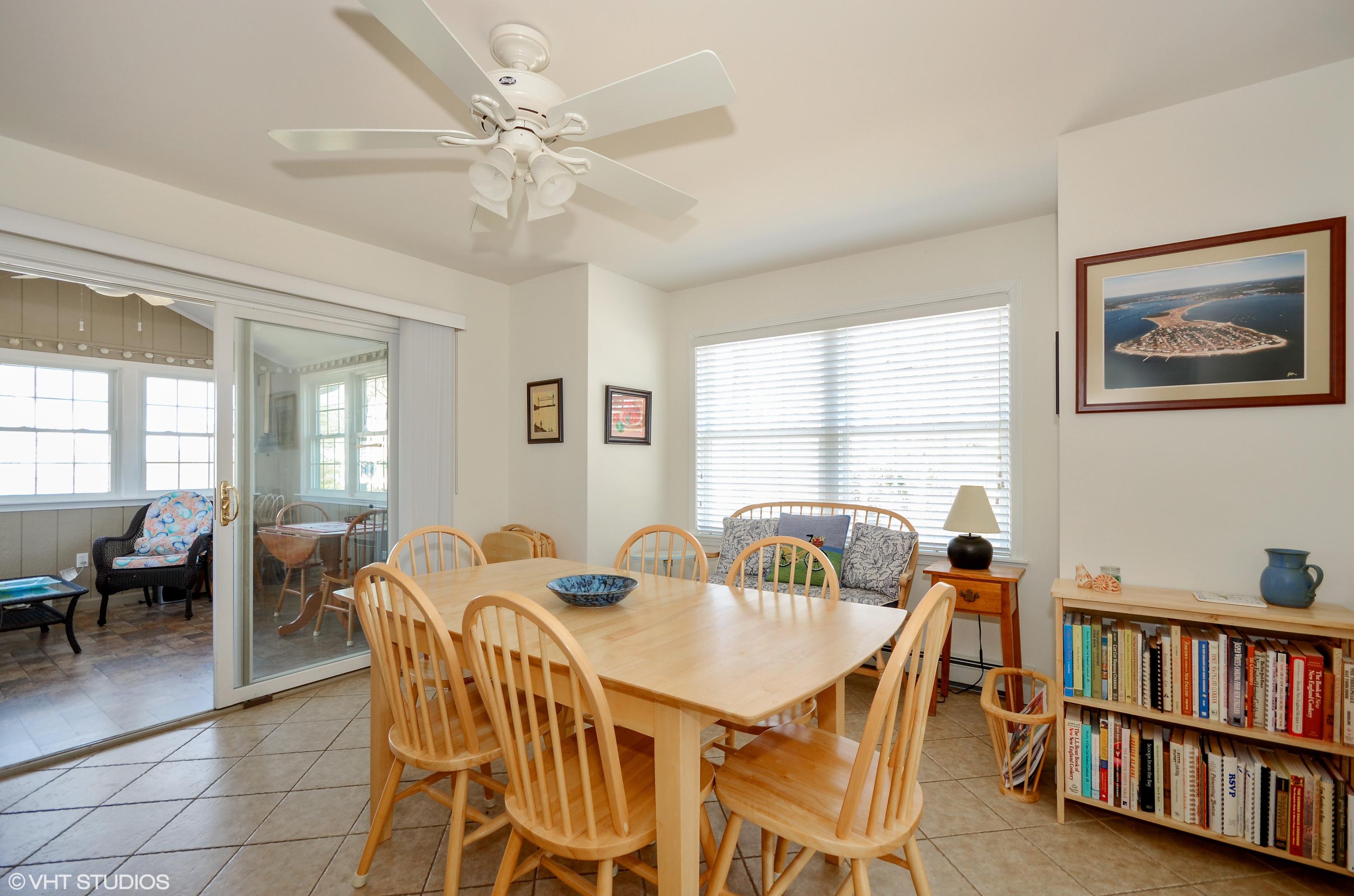 99 Mashnee Road Bourne, MA 02532 - Photo 8 of 25 a view of a dining room with furniture and a book shelf