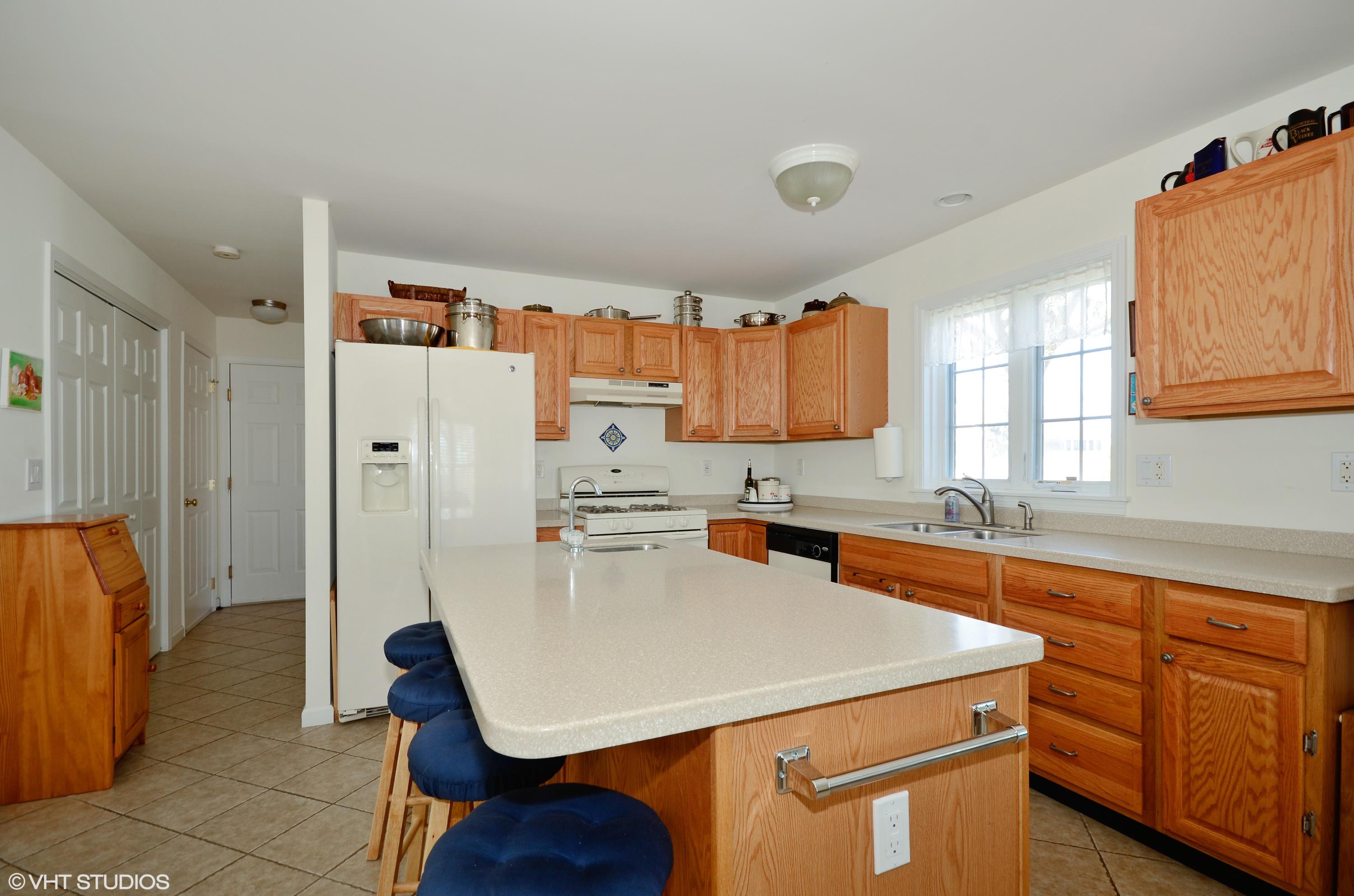 99 Mashnee Road Bourne, MA 02532 - Photo 9 of 25 a kitchen with stainless steel appliances a sink stove and refrigerator