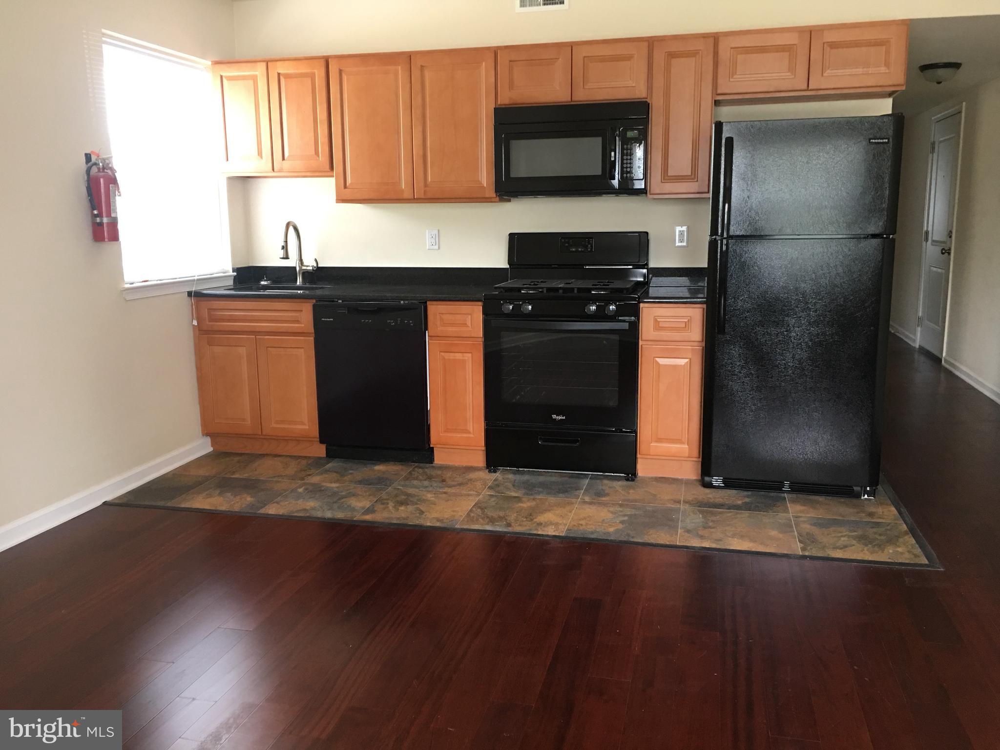 1 Pennsylvania Road, Unit 1 Glassboro, NJ 08028 - Photo 1 of 13 a kitchen with a sink and a refrigerator