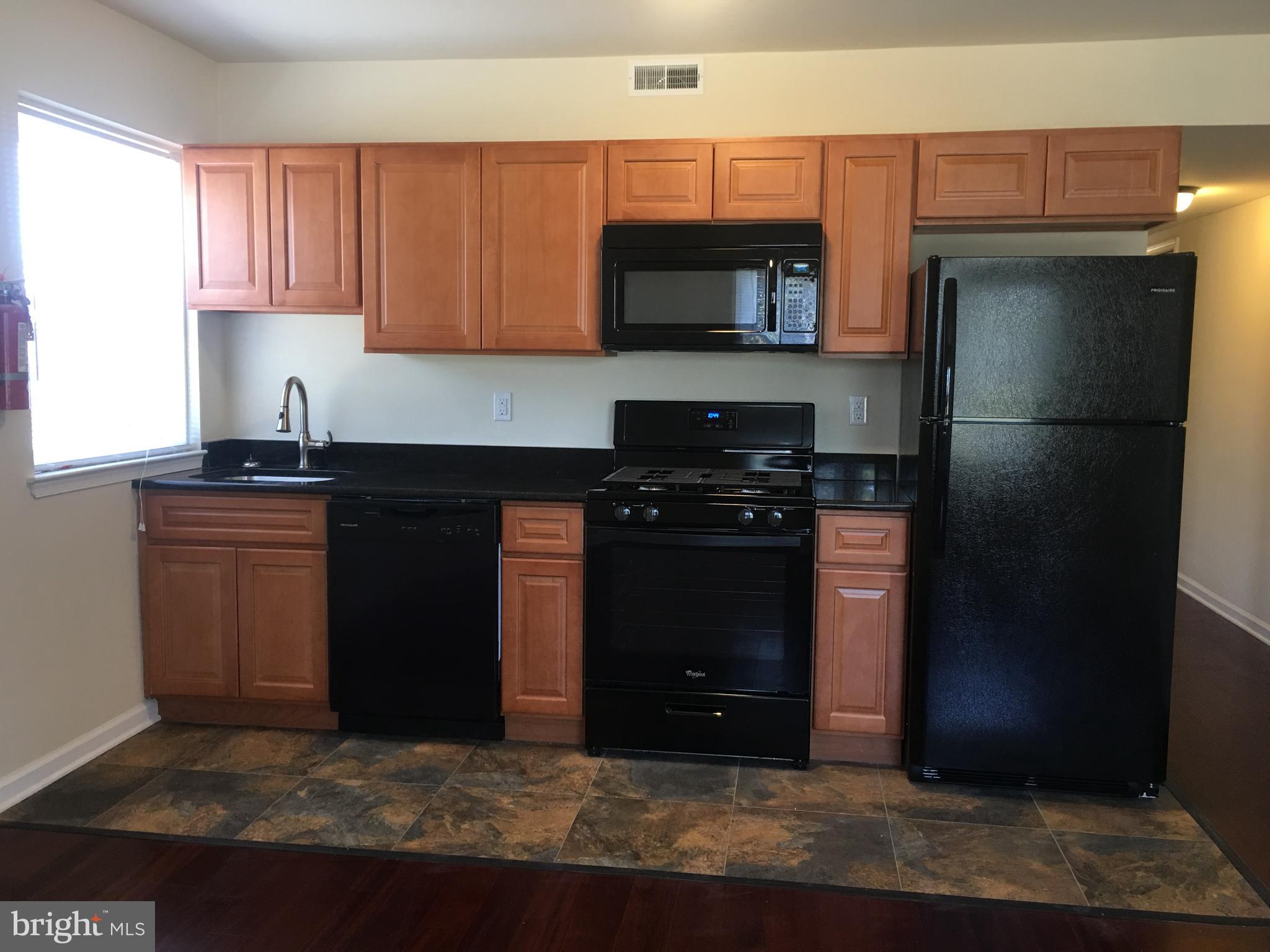 1 Pennsylvania Road, Unit 1 Glassboro, NJ 08028 - Photo 2 of 13 a kitchen with a sink and a refrigerator