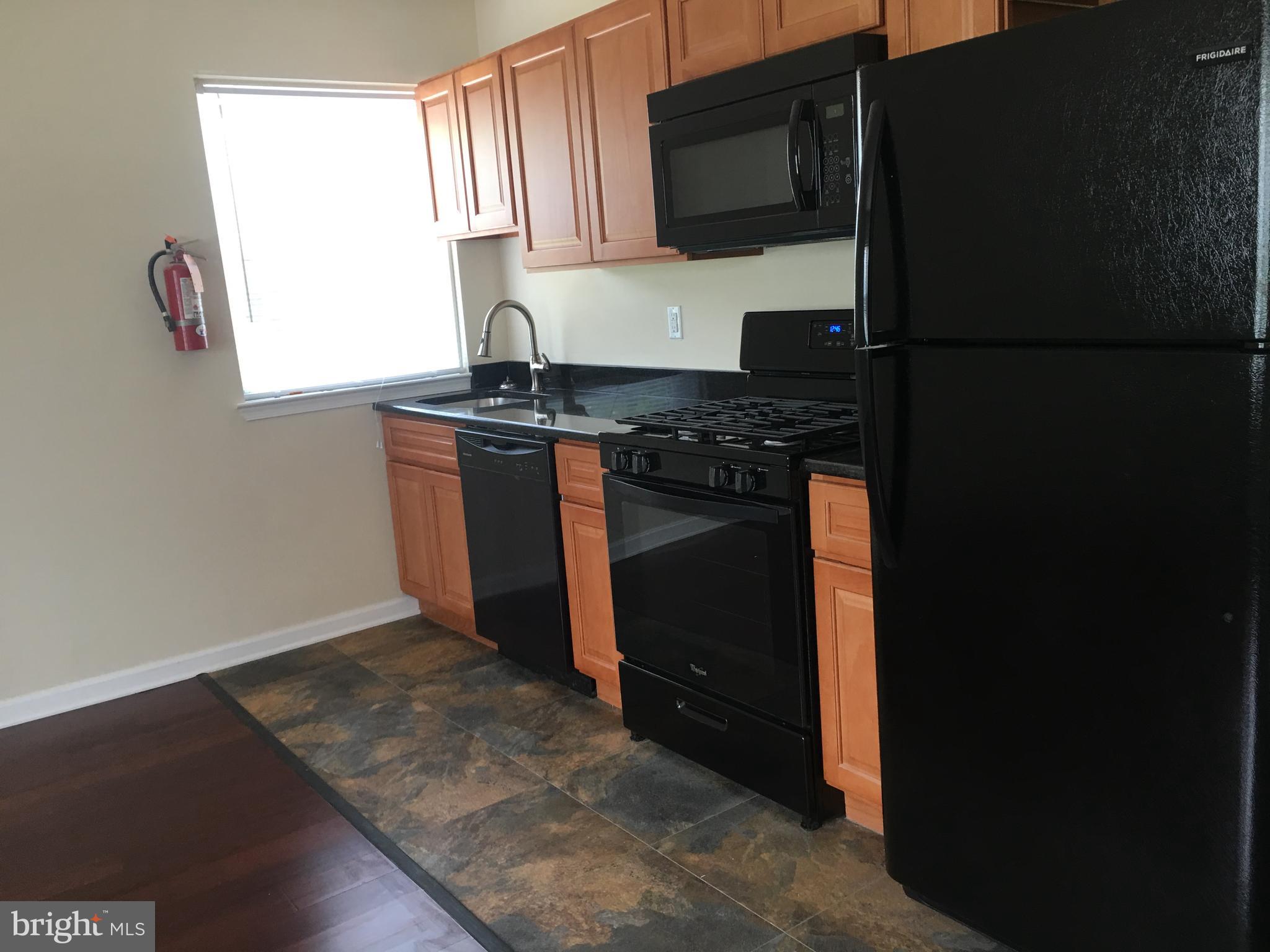 1 Pennsylvania Road, Unit 1 Glassboro, NJ 08028 - Photo 3 of 13 a kitchen with a refrigerator stove and microwave
