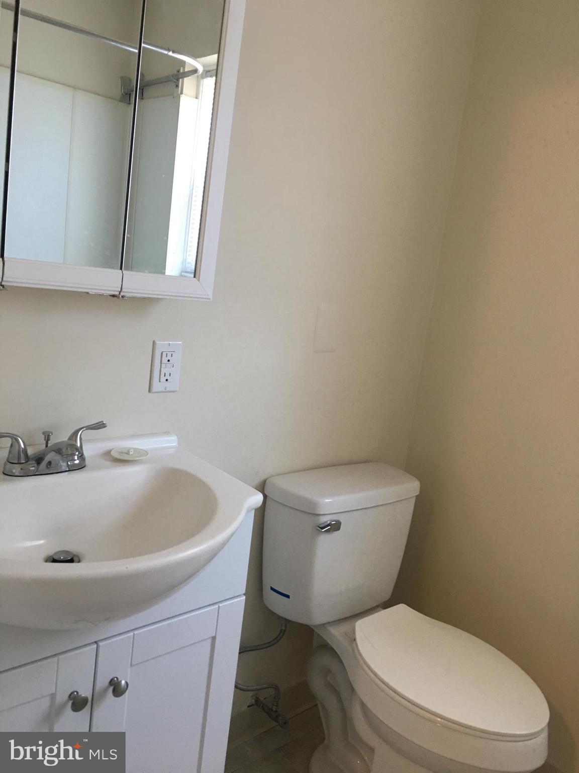 1 Pennsylvania Road, Unit 1 Glassboro, NJ 08028 - Photo 6 of 13 a white toilet sitting next to a bathroom sink