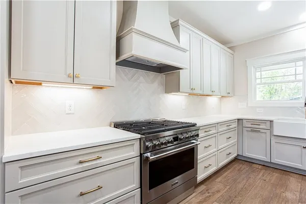 a kitchen with white cabinets and appliances