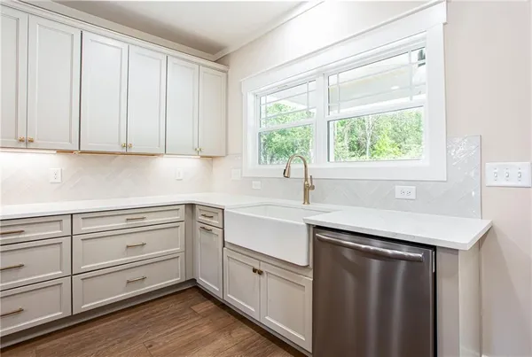 a kitchen with a sink cabinets and window