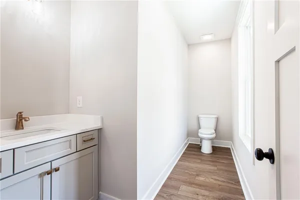 a bathroom with a sink toilet and a vanity