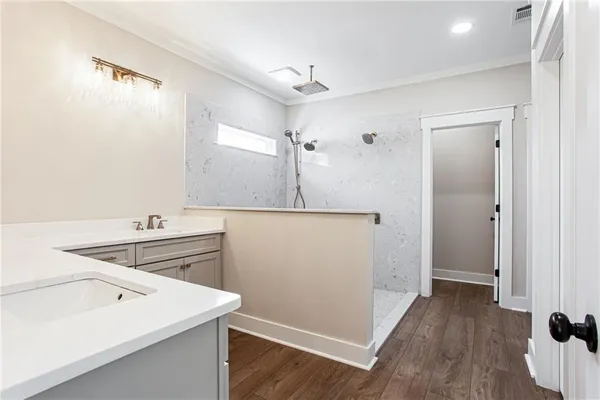a kitchen that has a sink a stove and a wooden floor