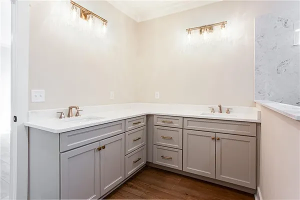 a spacious bathroom with a double vanity sink and mirror