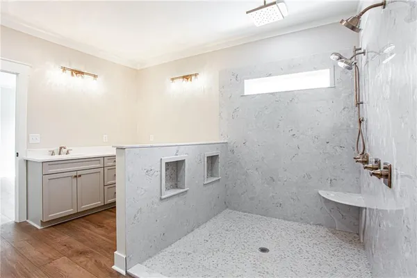 a bathroom with a sink a toilet and shower
