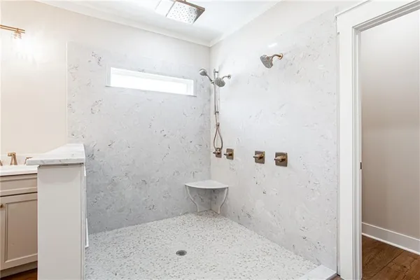 a bathroom with a granite countertop sink a toilet and shower