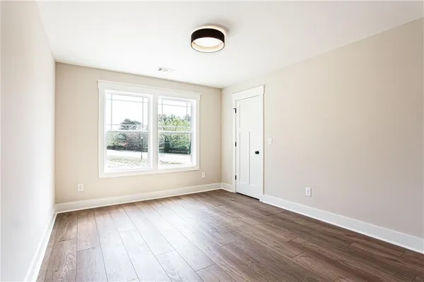 a view of room with wooden floor and window