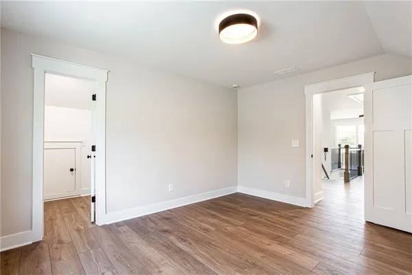 a view of a room with wooden floor