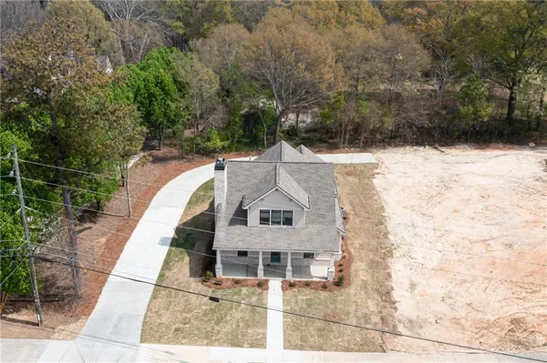 an aerial view of a house with trees