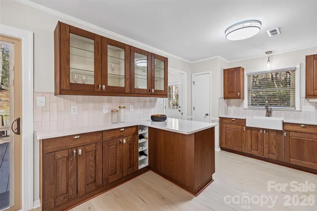 a kitchen with stainless steel appliances granite countertop a sink stove and cabinets