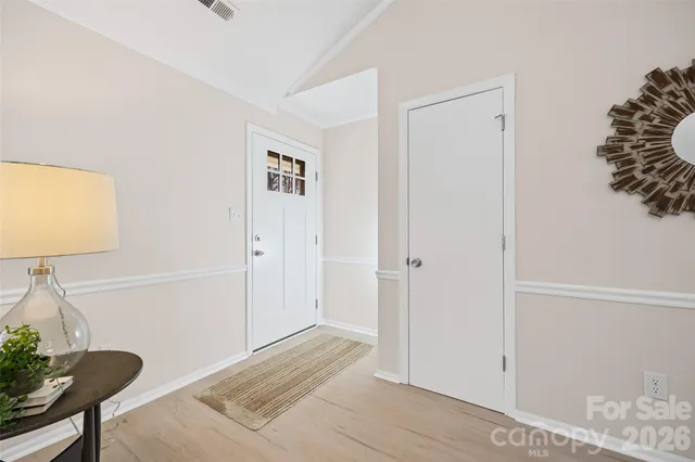 a view of a livingroom with wooden floor and chair