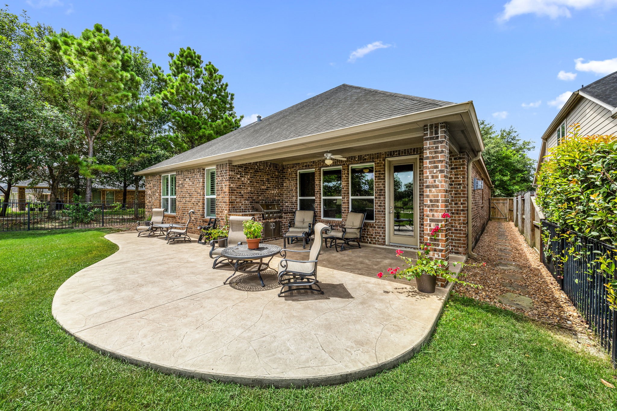 27642 Linden Ridge Lane Fulshear, TX 77441 - Photo 30 of 42 The stamped concrete patio extends the full length of the home, providing an abundance of space for outdoor dining, seating areas, and entertaining. This expansive design enhances the Backyard experience and offers the perfect setting for gatherings or quiet evenings overlooking the views.