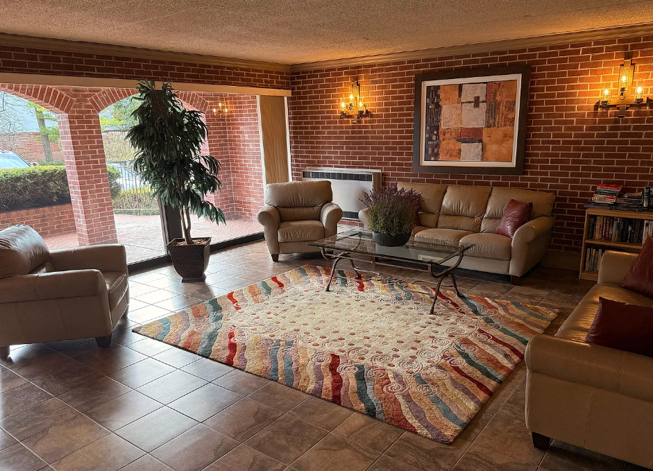 a living room with furniture and a potted plant