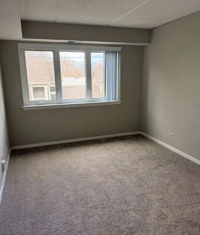 a bathroom with a granite countertop sink a toilet a mirror and shower