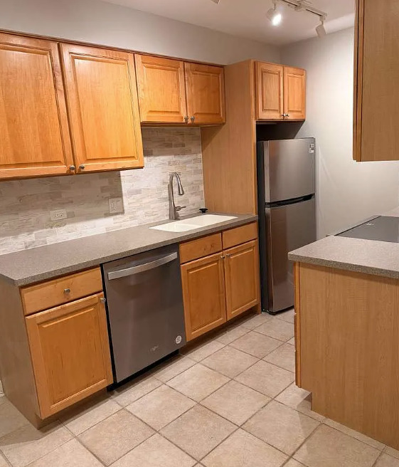2066 St Johns Avenue, Unit 304 Highland Park, IL 60035 - Photo 6 of 18 a kitchen with a sink a refrigerator and cabinets