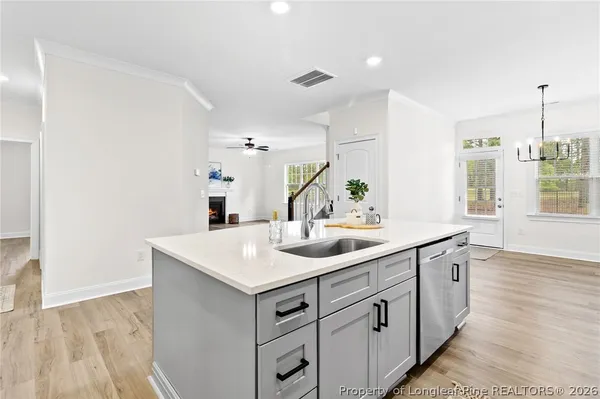 a bathroom with a sink a vanity and a large mirror