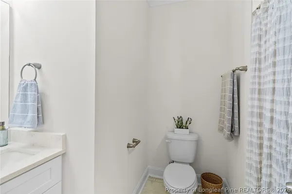 a white toilet sitting next to a bathroom sink