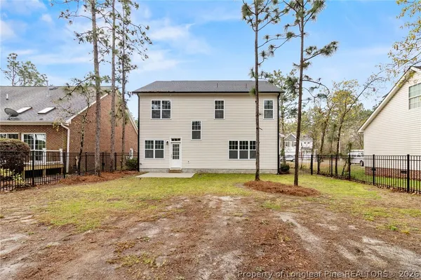a view of a house with backyard and a tree