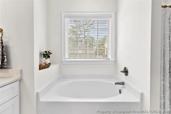 a white bath tub sitting next to a window
