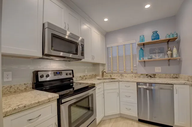 a kitchen with a sink stove and microwave