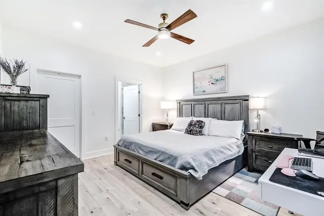 a bedroom with a bed and a dresser in it