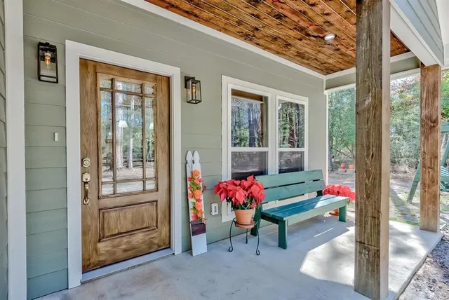 a living room filled with furniture and floor to ceiling windows