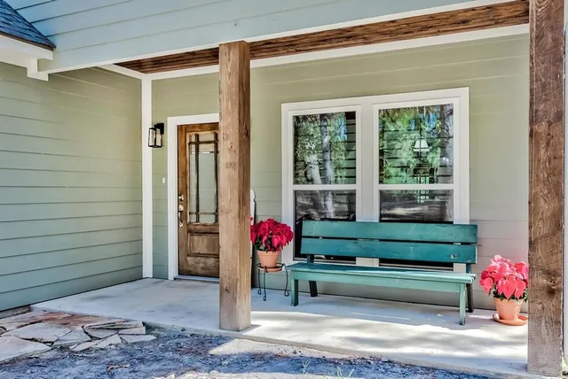a white bench sitting in front of a door