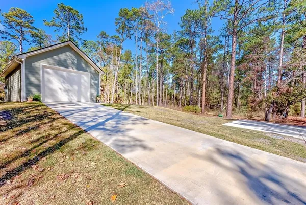 a view of backyard with a garden and trees