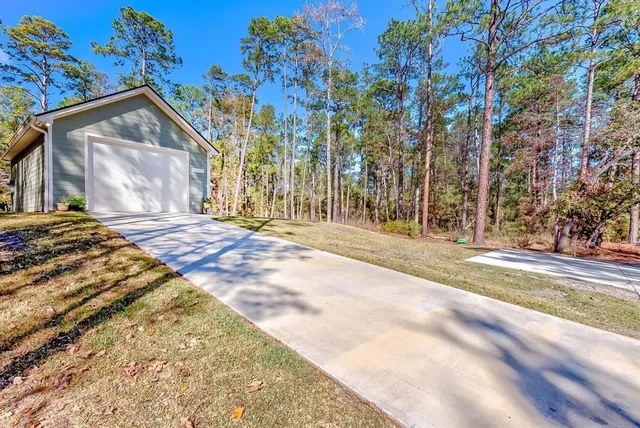a view of backyard with a garden and trees