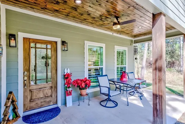a living room with patio furniture and a chandelier