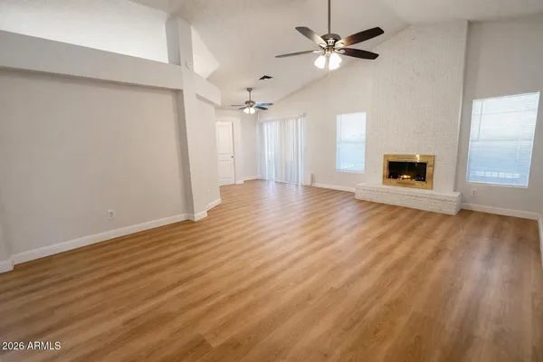 wooden floor in an empty room with a window