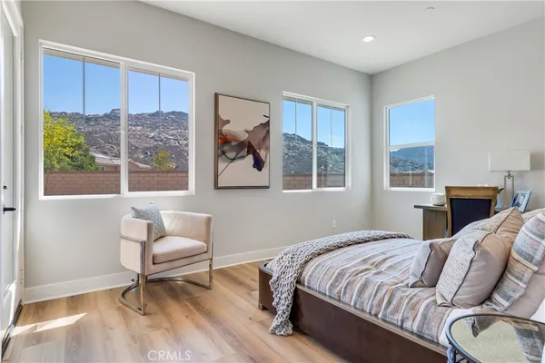 a bedroom with a bed and a chair