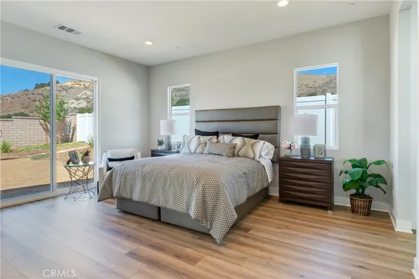 a bedroom with a bed and a couch