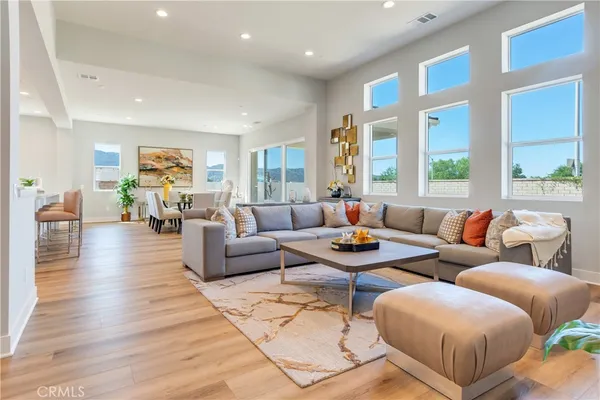 a living room with furniture and kitchen view