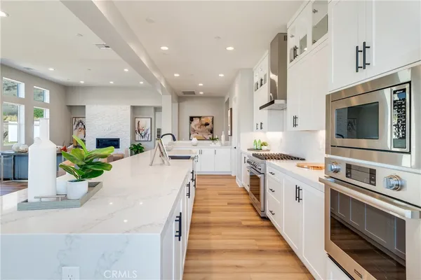 a kitchen with a stove and a white cabinets