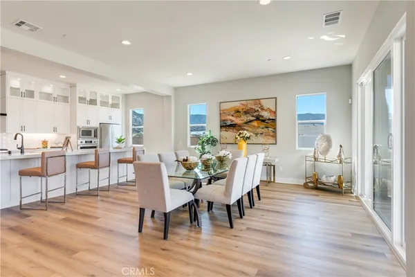 a view of a dining room with furniture window and wooden floor