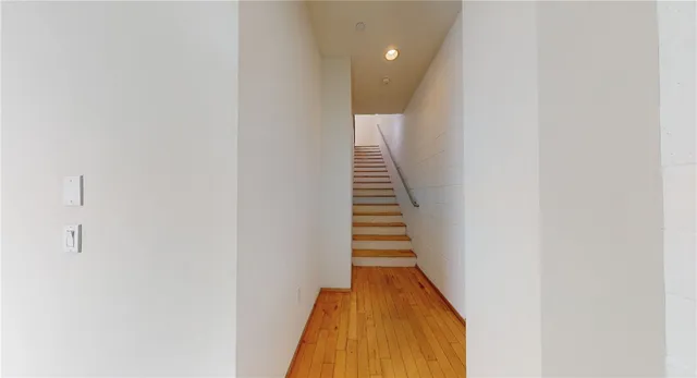 a view of a hallway with wooden floor