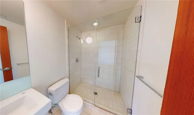 a bathroom with a shower and toilet