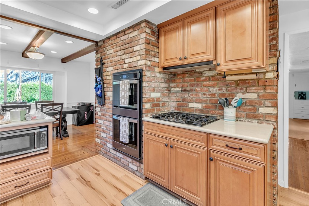 11460 Samoline Avenue Downey, CA 90241 - Photo 9 of 30 a kitchen with stainless steel appliances granite countertop a stove a sink and a microwave