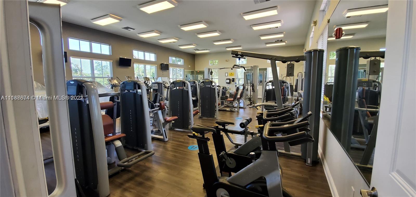 22731 Southwest 88th Place, Unit 101 Cutler Bay, FL 33190 - Photo 16 of 25 a view of a room with gym equipment