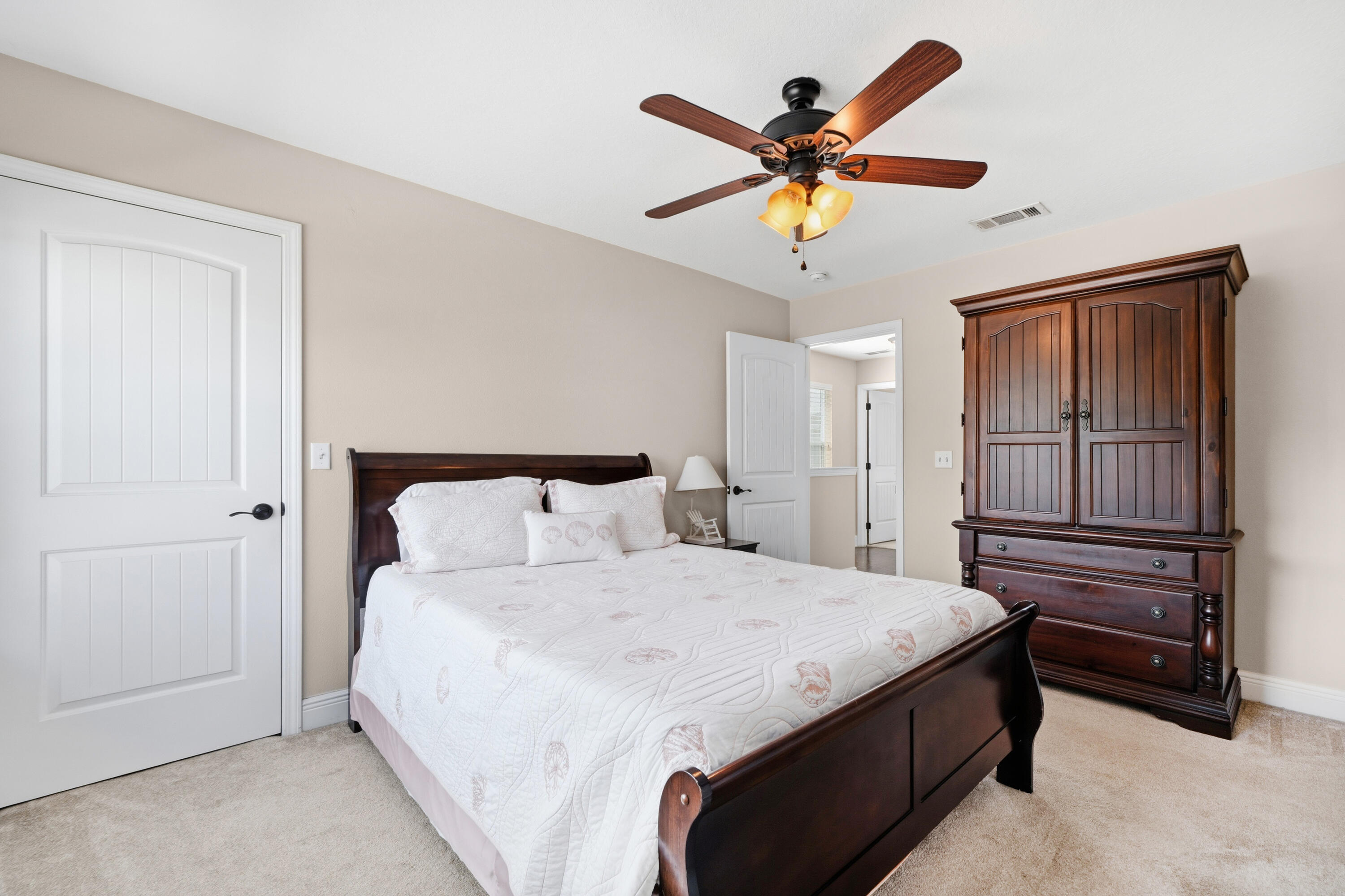 135 Grayling Way Inlet Beach, FL 32461 - Photo 22 of 61 a bedroom with a bed and a chandelier