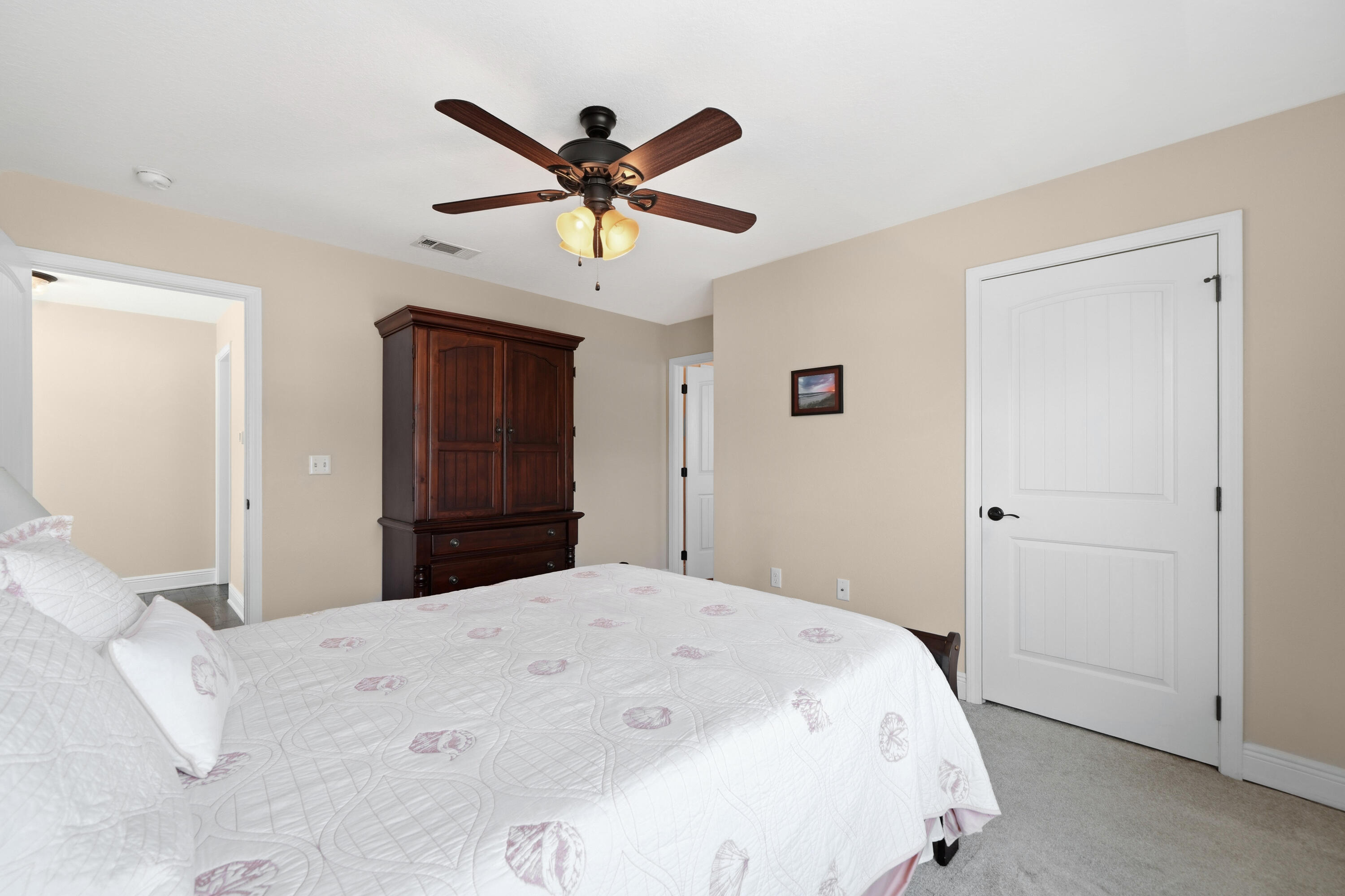 135 Grayling Way Inlet Beach, FL 32461 - Photo 23 of 61 a bedroom with a large bed and a chandelier
