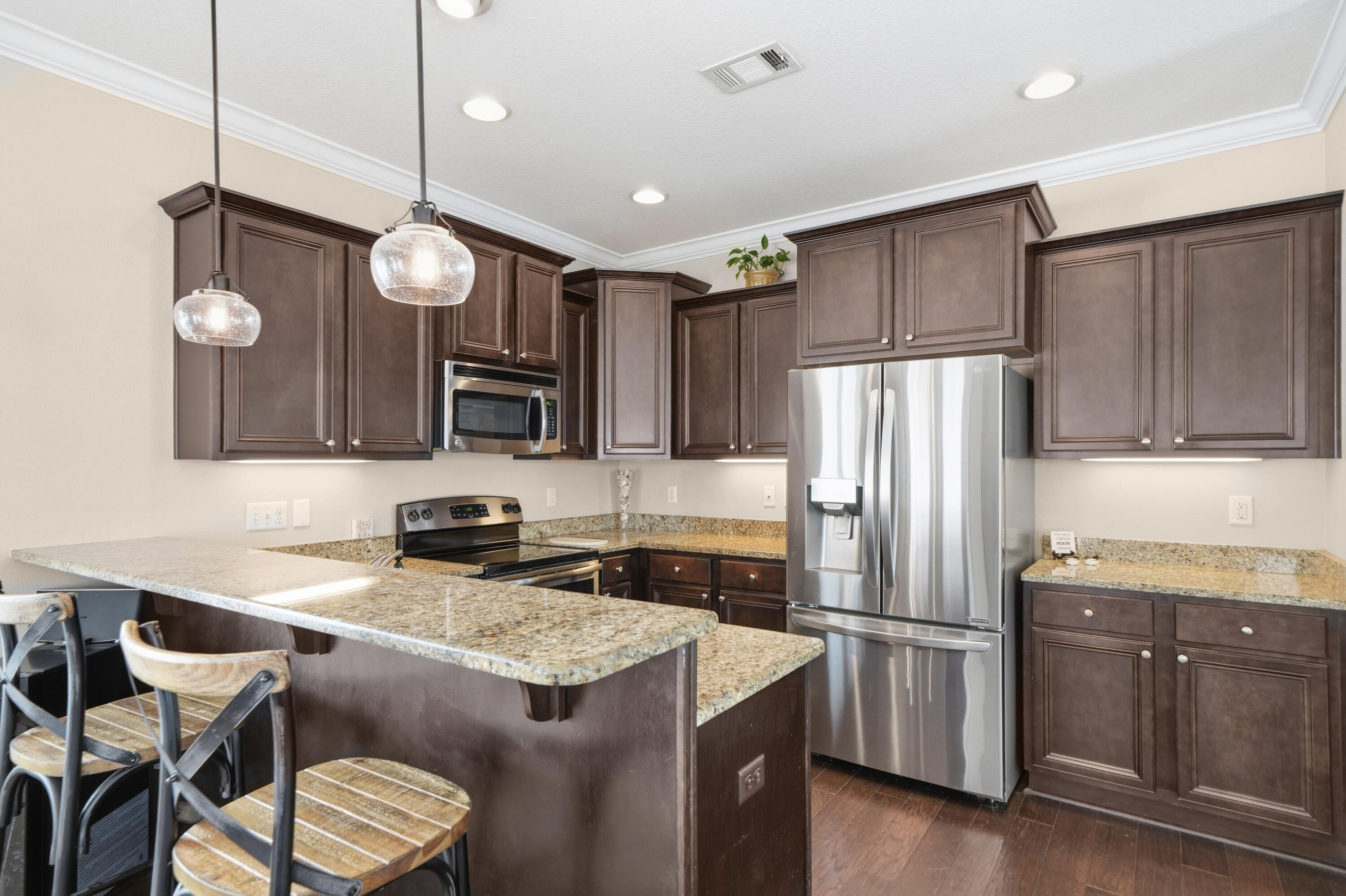 135 Grayling Way Inlet Beach, FL 32461 - Photo 35 of 61 a kitchen with stainless steel appliances granite countertop a sink a stove a refrigerator cabinets and chairs