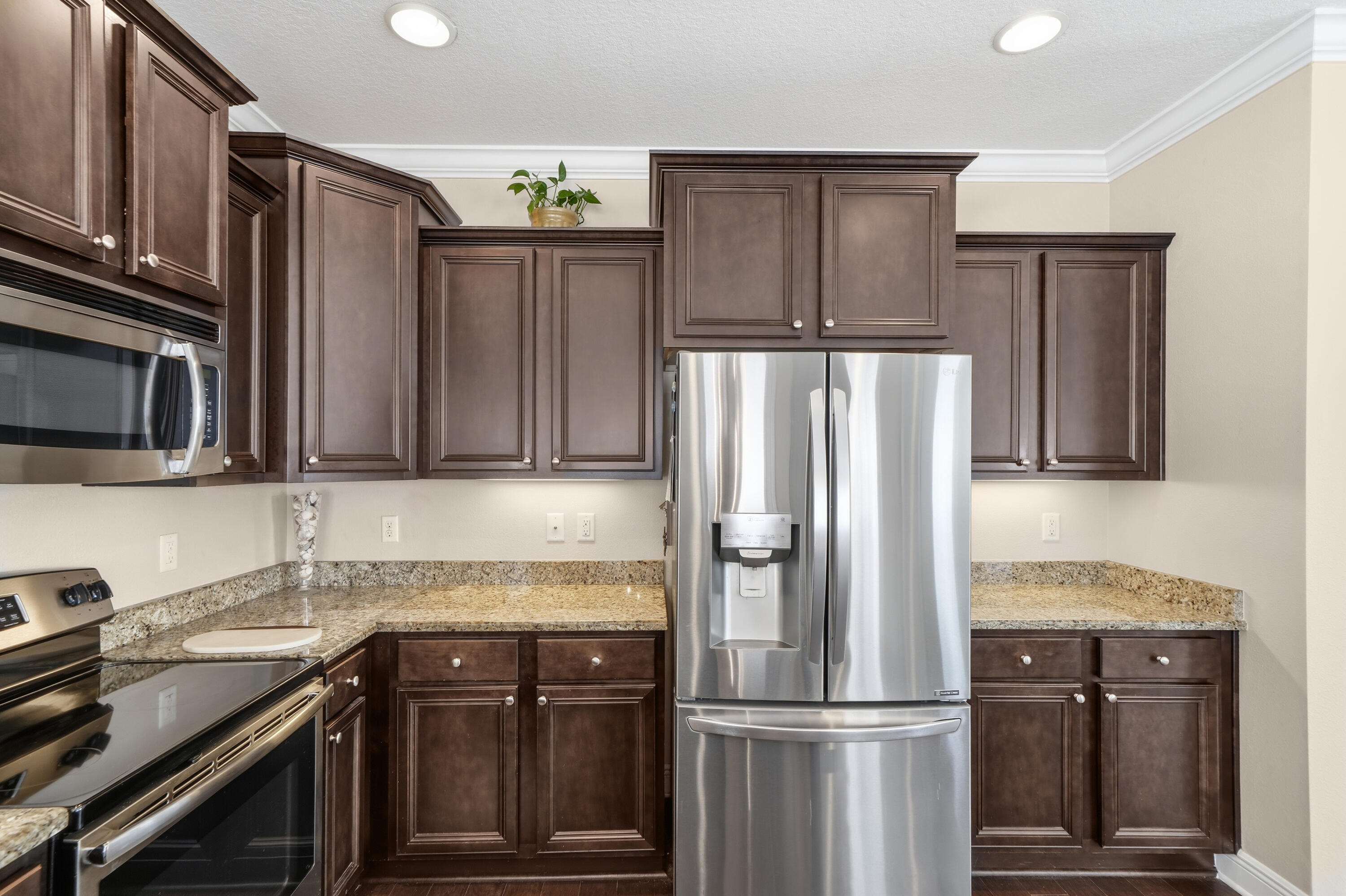 135 Grayling Way Inlet Beach, FL 32461 - Photo 36 of 61 a kitchen with granite countertop a refrigerator stove and microwave