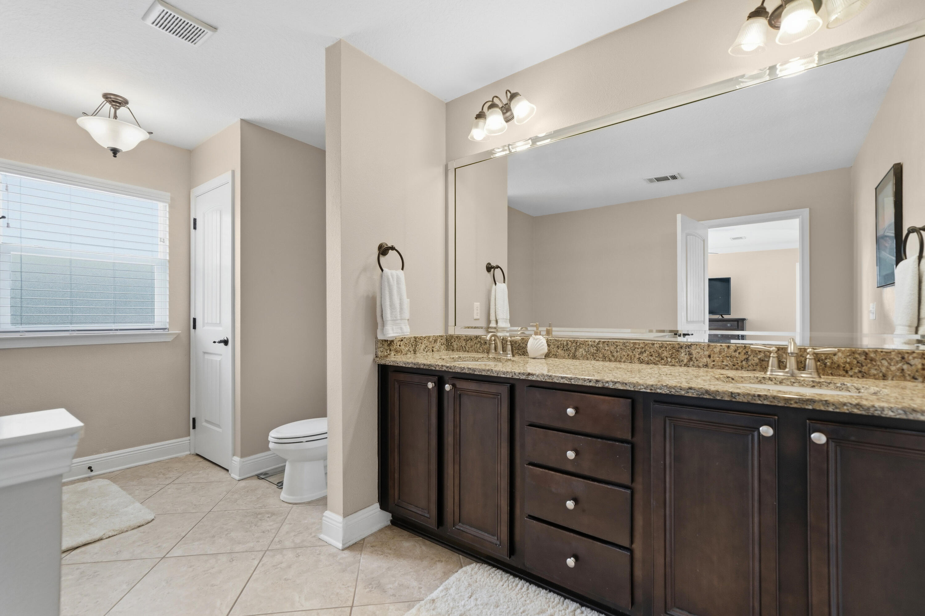 135 Grayling Way Inlet Beach, FL 32461 - Photo 7 of 61 a bathroom with a granite countertop sink a toilet and a mirror
