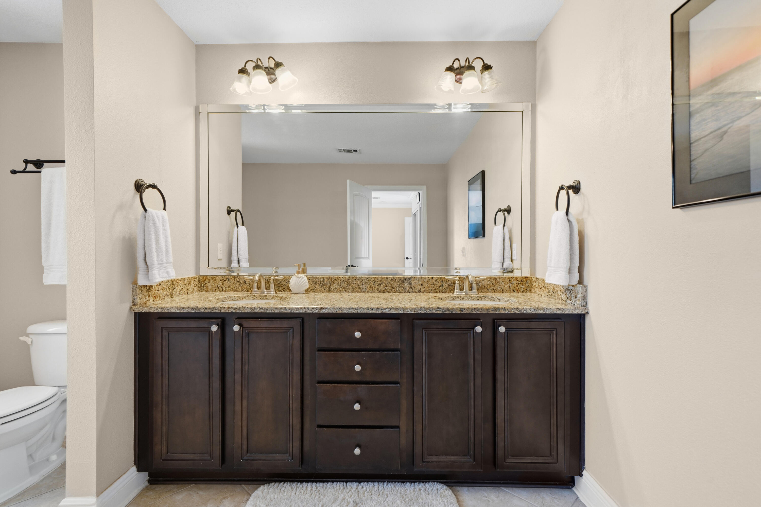 135 Grayling Way Inlet Beach, FL 32461 - Photo 8 of 61 a bathroom with a granite countertop sink a toilet and a mirror