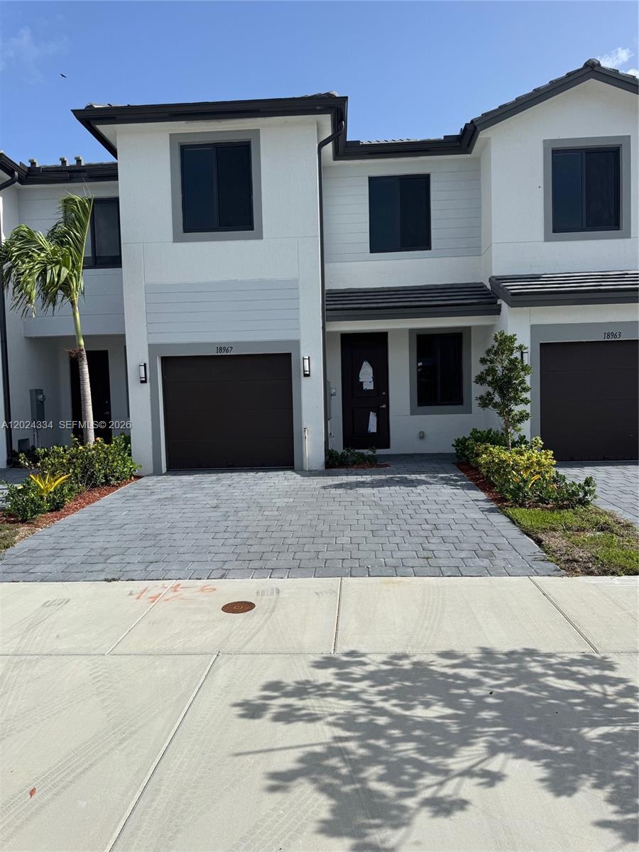 19115 Southwest 344th Terrace Homestead, FL 33034 - Photo 1 of 7 a front view of a house with a garage
